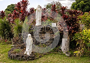 Statue of Mary being adored outside Saint Benedict`s Painted Church on the Big Island, Hawaii.