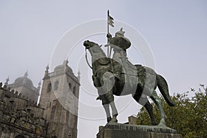 Statue of a medieval warrior knight  on his horse in the foreground and cathedral in the background. Knight VÃ­mara Peres and