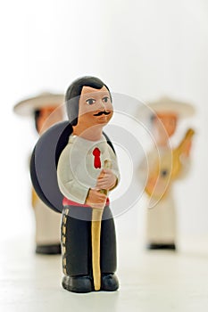 Statue of mexican man with sombrero on a white background