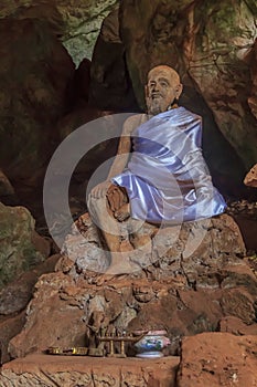 Statue of a monk in a cave temple in Thailand