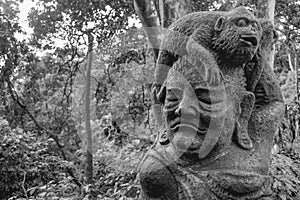 Statue of a monkey sitting at an old woman`s head in the sacret monkey forest in Ubud Bali