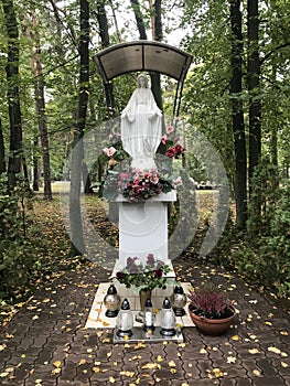 A statue of the Most Blessed Virgin Mary is adorned with flowers - Otwock - Poland - Polska