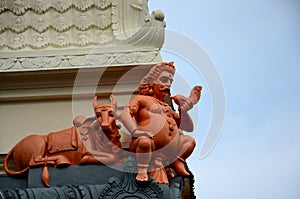 Statue of Nandi bull and one god holding conch at Sri Senpage Vinayagar Hindu temple Singapore photo