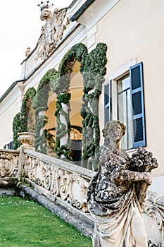 Statue near the balustrade of the lianas-twined arch of Villa Balbianello. Italy