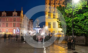 statue of Neptune fountain at Dluga Street in the old town at night. Gdansk, Poland