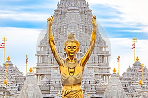 Statue of Nilkanth Varni with Akshardham Mahamandir temple in the back