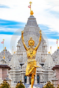 Statue of Nilkanth Varni with Akshardham Mahamandir temple in the back