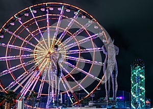 Statue of Nino and Ali at night on the carousel background and alphabetic tower. Batumi,Georgia at august of 2018