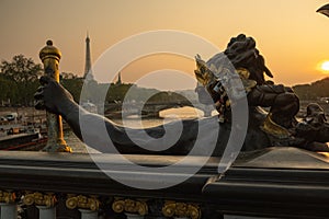 Statue of Nymphs with locks on Alexandre III bridge with Eiffel Tower in the background at sunset time in Paris