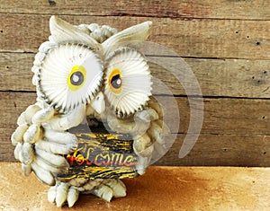 Statue of owl on wooden background still life
