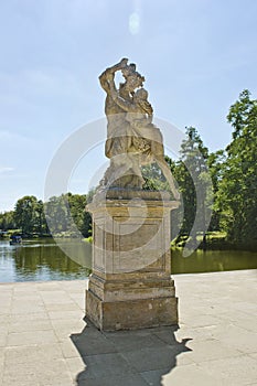 Statue of Pan with a girl by the lake in Park