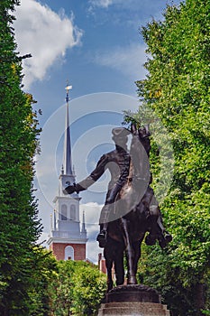 Statue of Paul Revere and spire of Old North Church between tree