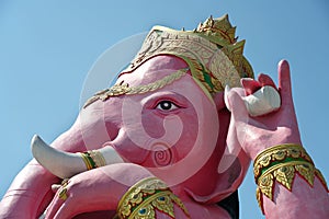 Statue of Pink Ganesha,Hindu god of wisdom or prophecy, on blue sky background