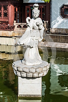 Statue on a pond in Fang Bang Zhong Lu old city Shanghai China photo