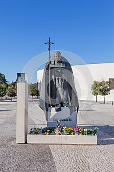 Statue of Pope John Paul II with the Basilica of Most Holy Trinity