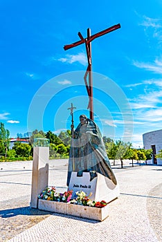 Statue of pope John Paul II and High Cross at Fatima, Portugal