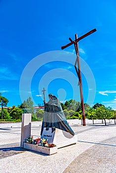 Statue of pope John Paul II and High Cross at Fatima, Portugal