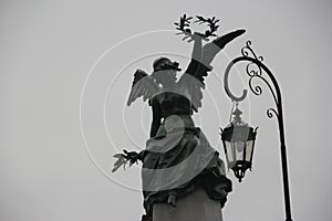 Statue raising crown, Recoleta Cemetery. Caba photo