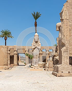 The statue of Ramses II with his daughter Merit-Amon in the temple of Amun-RA in Karnak, Luxor, Egypt