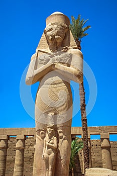 Statue of Ramses II with his daughter Merit-Amon in the temple of Amun-RA (the temple of Karnak in Luxor)