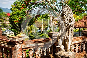 Statue of Rangda, the demon queen. Water Palace of Tirta Gangga in East Bali, Indonesia. Stone figure of balinese god.