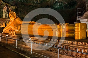 Statue of Reclining Buddha in a cave temple in Thailand