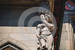 Statue of the right side of the Town hall building of Bern Switzerland that depicts lie and cowardice