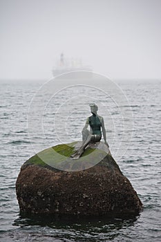 Statue on rock in Vancouver harbor