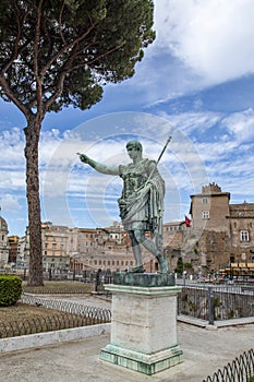 Statue S.P.Q.R. IMP CAESARI NERVAE F TRAIANO OPTIMO PRINCIPI on street Via dei Fori Imperiali, Rome, Italy