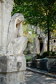 Statue of a sad woman on the Pere Lachaise cemetery in Paris