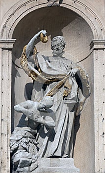 Statue of Saint on baroque Jesuits church in Vienna photo