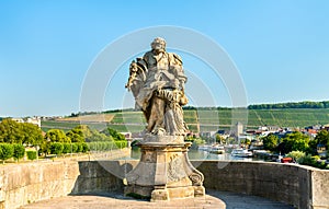 Statue of Saint Joseph with Jesus on Alte Mainbrucke, the old bridge across the Main river in Wurzburg, Germany photo