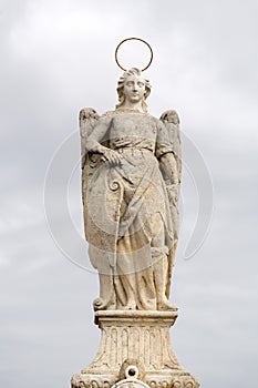 Statue of Saint Raphael in the middle of the Roman Bridge in Cordoba, Spain photo