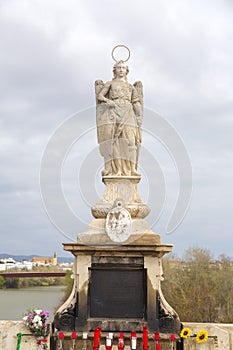 Statue of Saint Raphael in the middle of the Roman Bridge in Cordoba, Spain photo
