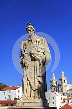 Statue of Saint Vicente de Fora in Lisbon and house roofs