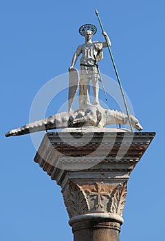 statue of saintTheodore slaying the dragon over the column in th