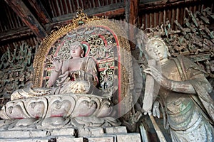 Statue of Sakyamuni buddha and female bodhisattva photo