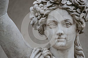 Statue of sensual busty and puffy renaissance era woman in circlet of flowers, Potsdam, Germany, details, closeup