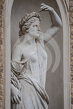 Statue of sensual Roman renaissance era woman in circlet of bay