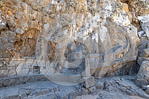 A statue of a ship carved into the rock on the Acropolis