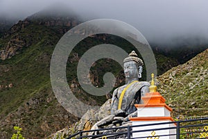 Statue of Siddhartha Gautam Buddha overlooking the Muktinath Village in Upper Mustang, Nepal