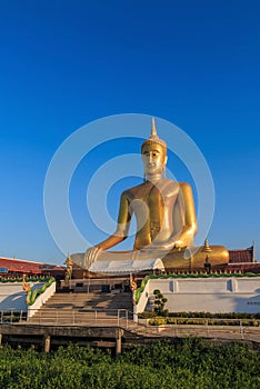 The statue of sitting Buddha in Bangkok Thailand with blue sky