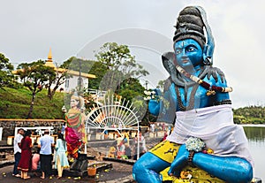 Statue of a Sitting Person by the Water