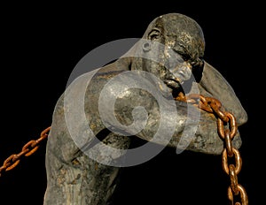 Statue of a Slave Carrying a Boat Using a Chain photo
