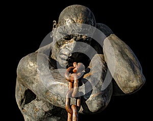 Statue of a Slave Carrying a Boat Using a Chain photo