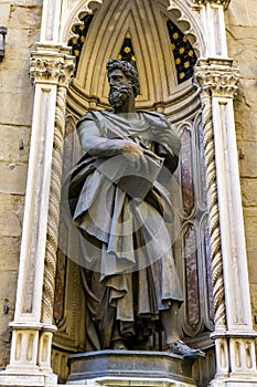 Statue of St. Luke by Giambologna, at Orsanmichele church exterior in Florence, Italy photo