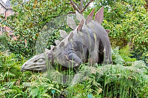 Statue of a stegosaurus dinosaur in front of the Gallery of Paleontology and Comparative Anatomy in Paris, France