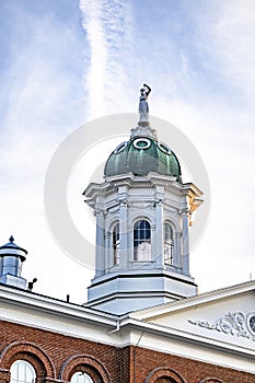 Statue of Themis with scales in her hand on the dome of a building in New England