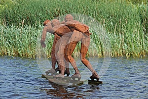 Statue of three skaters skating on It Wiid in Eernewoude in Friesland