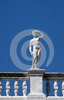 Statue at the top of National Library of St Mark`s Biblioteca Marciana, Venice, Italy photo